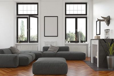 A modernly designed living room complete with two sets of casement windows below two picture windows
